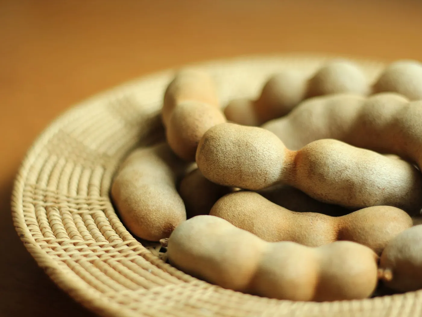 Tamarind pods in a woven basket